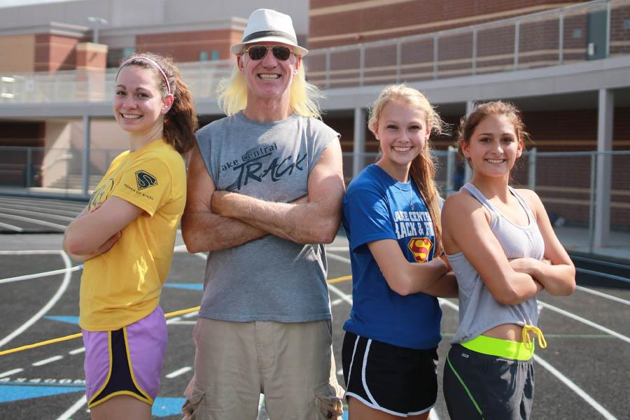 Renee DiNino (12), Mr. Ron Fredrick, English, Nicole Verdeyen (12) and Alexandria Tyler (12) cross their arms on the track. Mr. Fredrick was given the Coach of the Year award by the Post-Tribune.