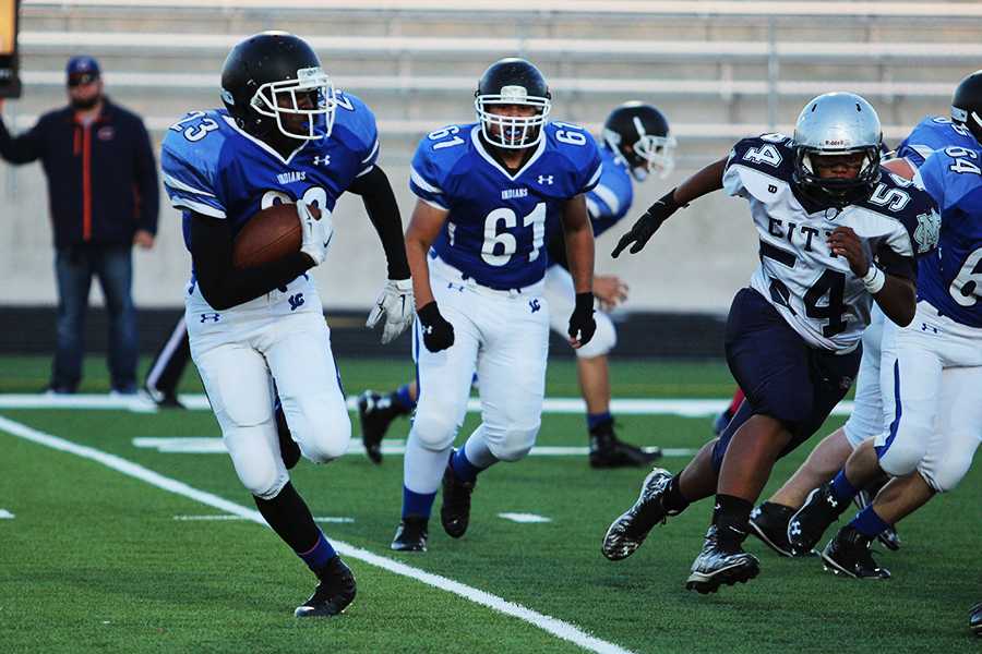 Cameron Williams (9) runs down the field with the ball in hand. The game started at 6 p.m.