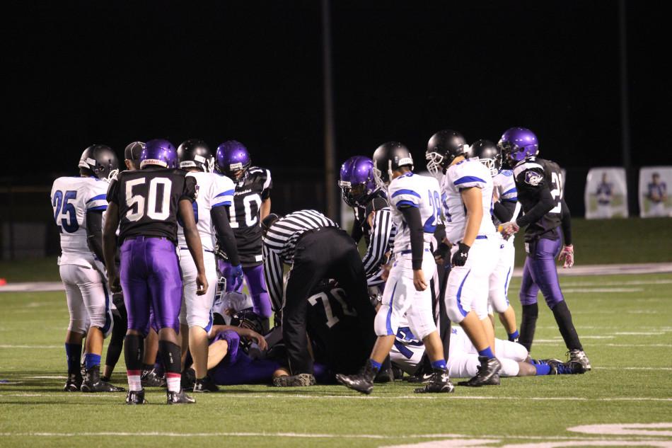 As the referee tries to make a call, both of the teams surround the tackle. The next game will be on Saturday, Oct. 17.