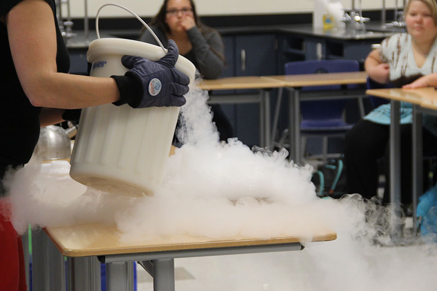 Ms. Lauryn Beneturski, Science,  pours liquid nitrogen into a pan. The pan was filled with soapy water, which formed frozen bubbles.