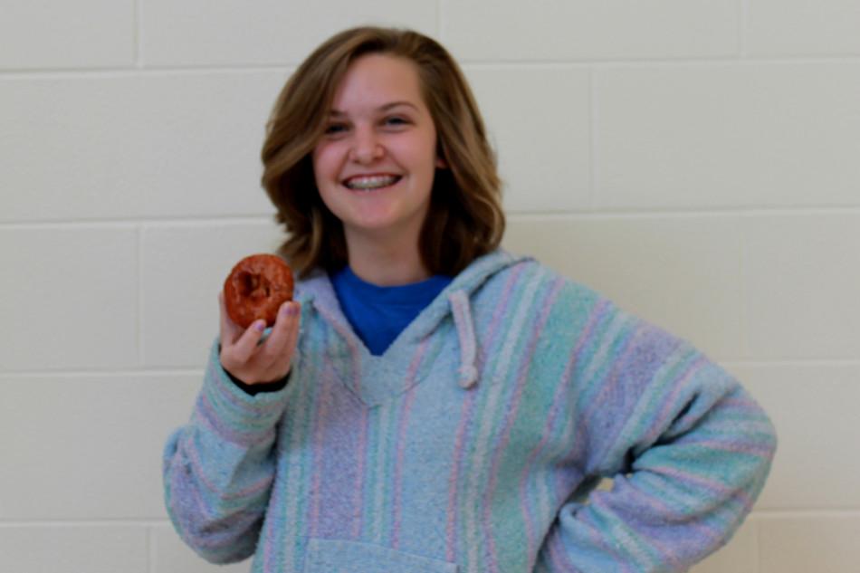 Rebecca Ashby (10) holds a County Line Orchard doughnut. This doughnut was purchased with a dozen for $8.