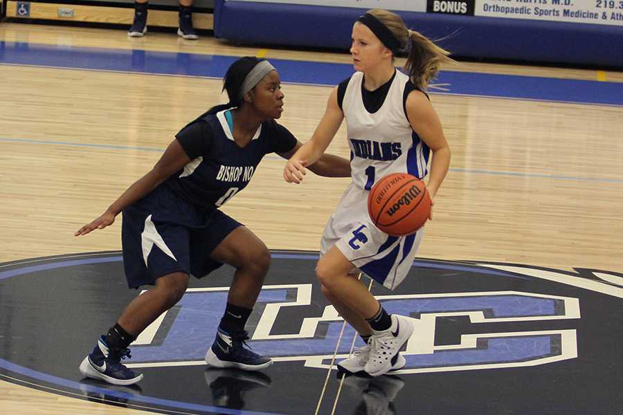 Jaidyn Brown (9) drives the ball to the basket while a player on the opposing team guards her. The Lady Indians finished the game with a 29 point lead against Bishop Noll.