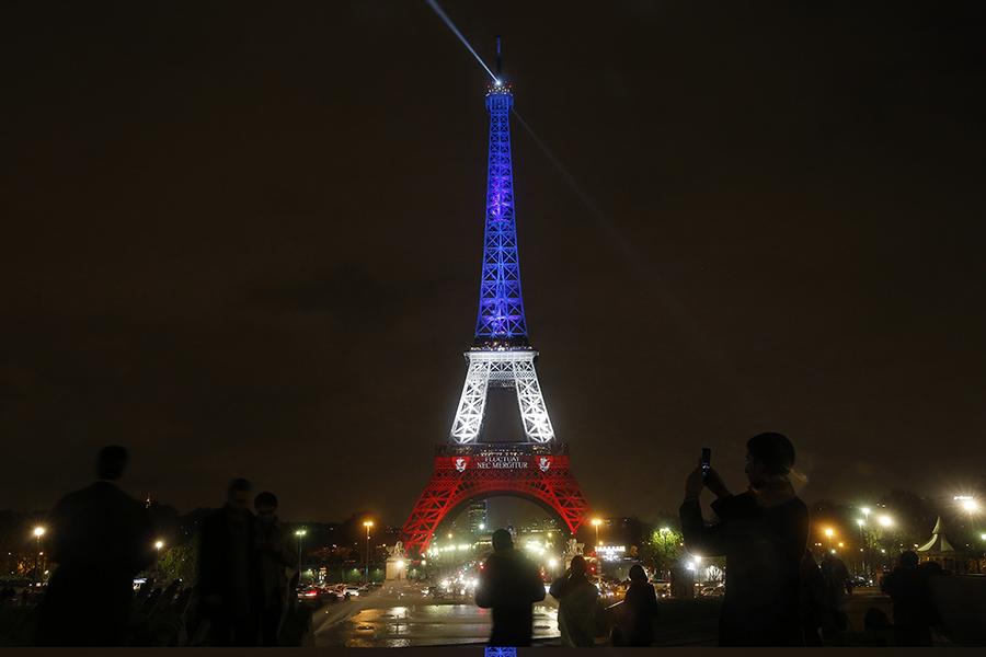 On the third day of national mourning, the Eiffel Tower was lighted in the national colors after going dark on Nov. 16, 2015 in Paris. Used with limited license: Carolyn Cole/Los Angeles Times/TNS.