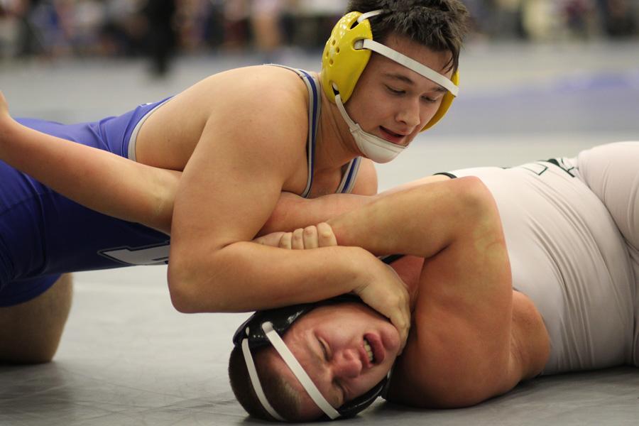 Joseph Szydlo (11) attempts to pin his opponent’s shoulder to the ground. Szydlo received 5th place at the Harvest Classic in the 220-pound weight class.