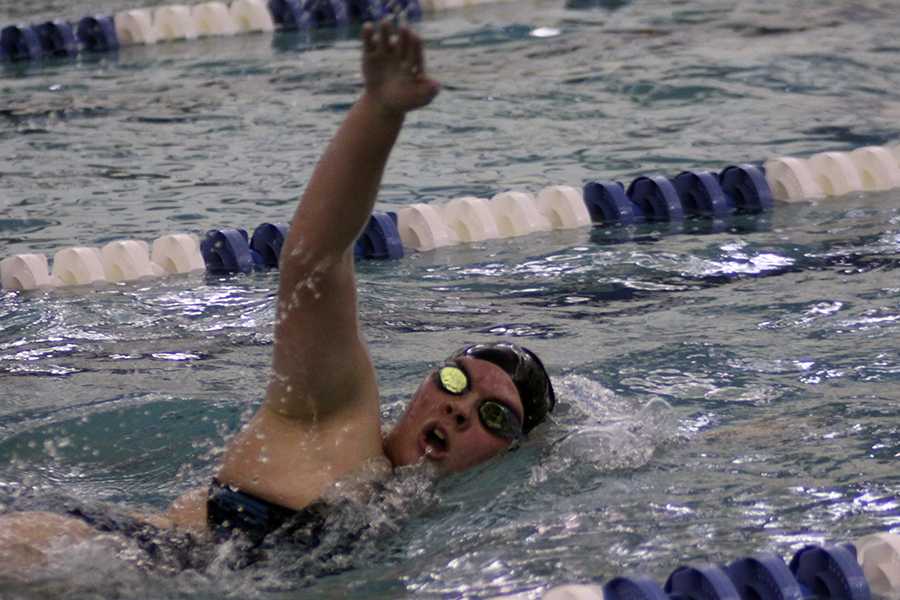 Maura Lake (11) swims the 500 freestyle on Dec. 12. Lake was one of five varsity girls to swim this event. 