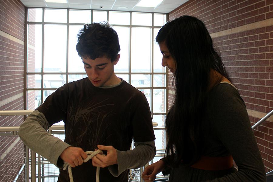 Matthew Hughes (11) teaches Sneha Shatish (10) how to do a sheet bend knot. The knot tying event tests technicians ability to tie a clove hitch, half hitch, sheet bend and one-handed bowline.