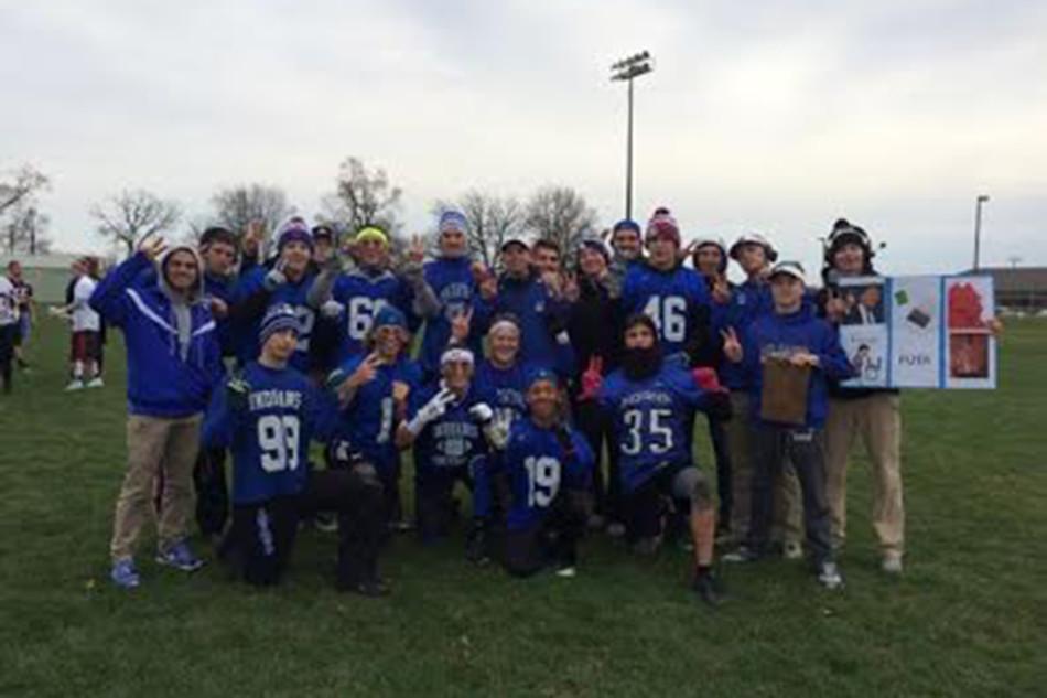 The draft team gathers for a team picture at the conclusion of a game on the football field at Kahler Middle School. Even though the weather permitted this to be a comfortable game, the teams will continue to play even in the snow and winter temperatures. 