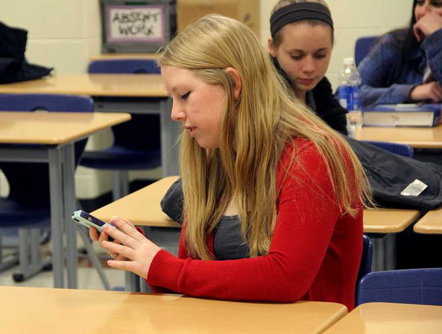 Eva Kimberly (12) reads a quote off of her phone during Senior Class Cabinet. The students decided on the quote “I dont know where Im going from here, but I promise it wont be boring,” by David Bowie as the class motto. 