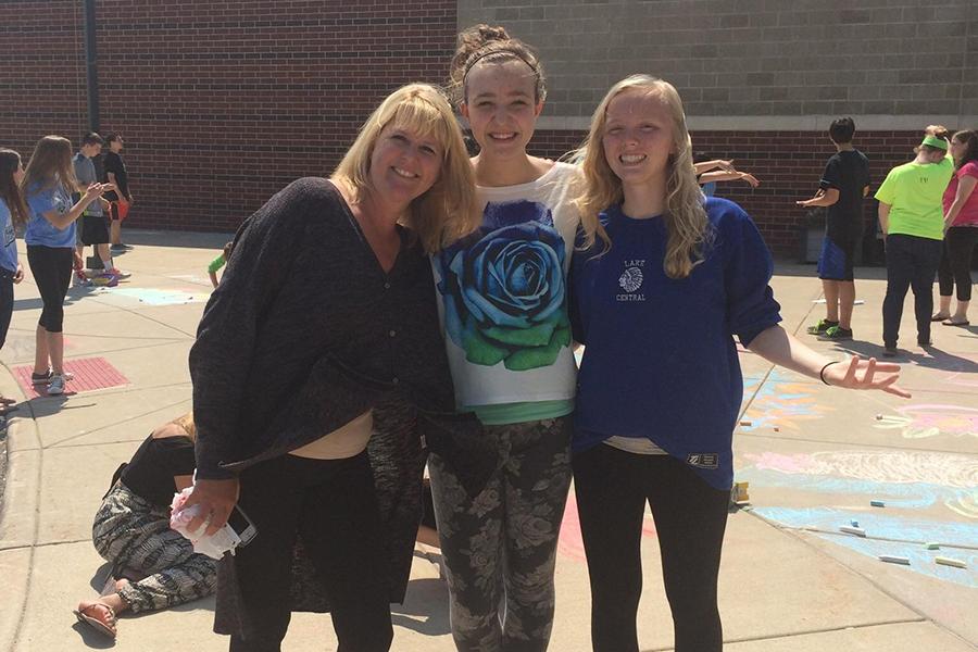 Nina Zochalski (10) and Jenna Bunner (10) pose for a picture with former teacher Mrs. Michele Tyler, English, on their last day of class their eighth grade year. This photo was taken on a sunny day in May 2014. Photo submitted by: Nina Zochalski
