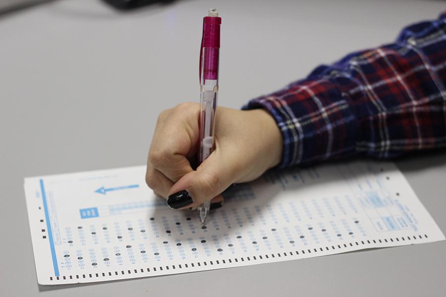 A girl sits down to take a standardized test during school. The ACT and SAT exams are some of the most common standardized tests taken around the nation.
