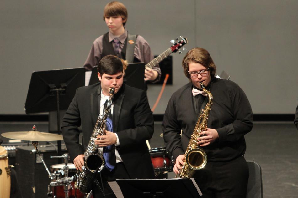 Two tenor saxophone players, Nicholas Perez (12) and Benjamin Moore (12), stand for their solos. Perez and Moore were part of the Jazz II band.