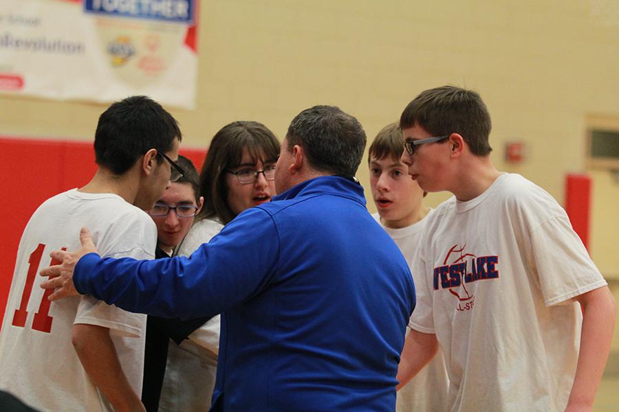 Members of the West Lake All-Stars huddle up around their coach, Asst. Principal Tim Powers, during their game against Crown Point.  After a lot of back and forth, the All-Stars lost the game 36-34.
