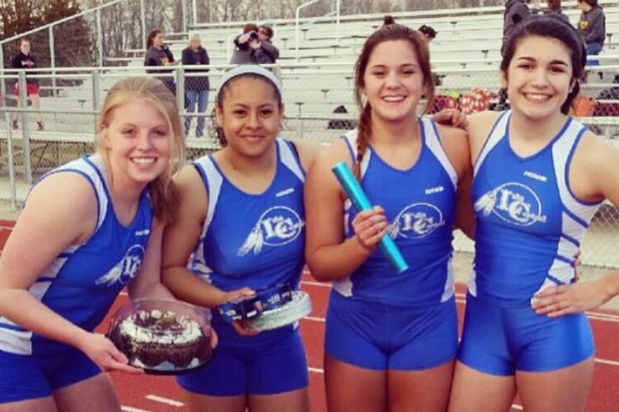 Kelly Joy (11), far right, poses with teammates at a track meet last year.  Joy placed third at this meet. Photo submitted by: Kelly Joy (11) 