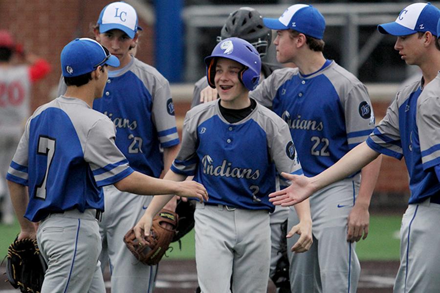 Benjamin Bosold (9) gets congratulated after making it home. The game started at 4:30 p.m.