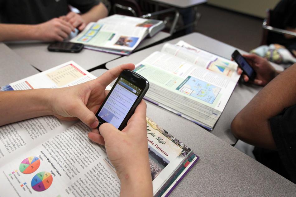 Ninth grader Tyler Jackson uses his smart phone to seek out information on New Zealand during world geography at Princeton High School in Princeton, Texas, on April 27, 2012. The school has launged a program allowing students to take video and audio recordings of classes. (Used with limited license: Kye R. Lee/Dallas Morning News/MCT)