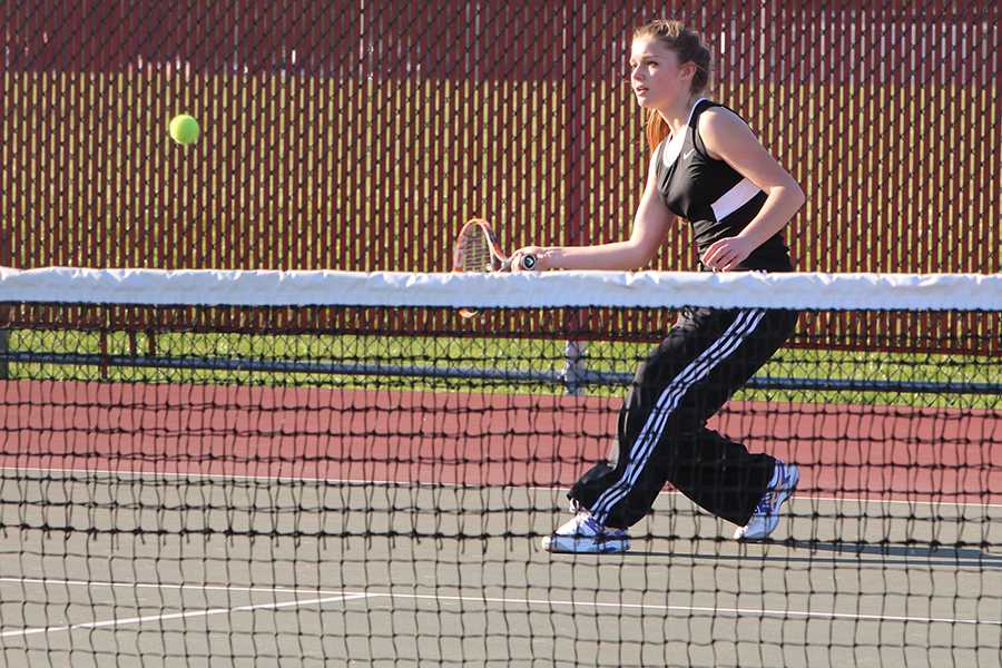 Claire Gronek (10) returns a groundstroke to continue the rally between her and her Lowell opponent. Gronek played number two varsity singles in her match.