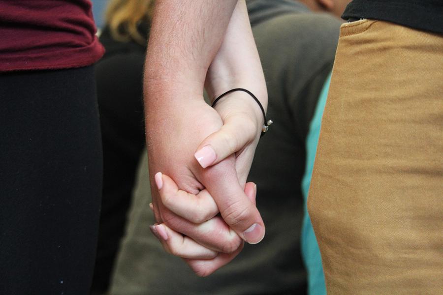 An anonymous couple holding hands. This couple has been together for a little over a year.