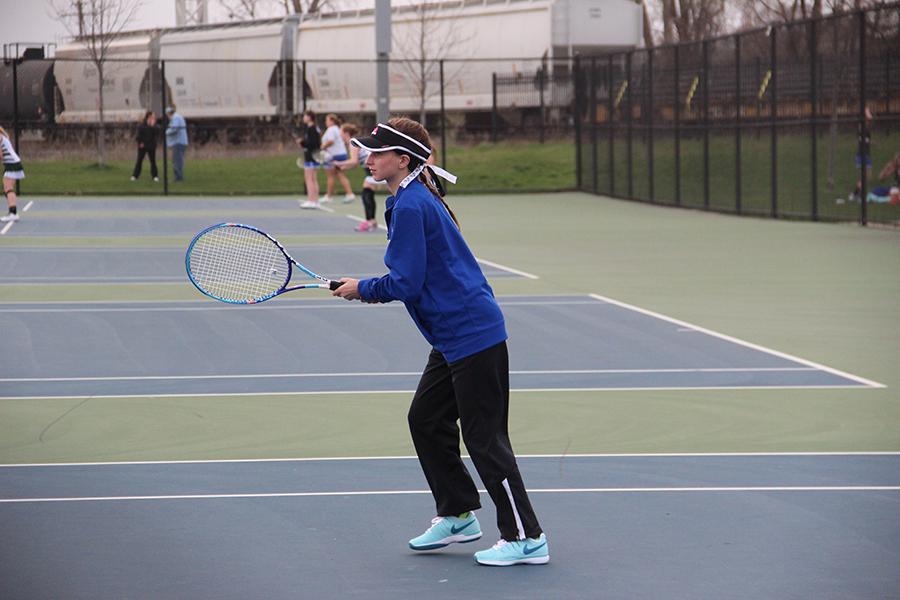 Rachel Eder (10) warms up before a match. This is Eder’s second year on the tennis team. Photo by: Emma Degroot.