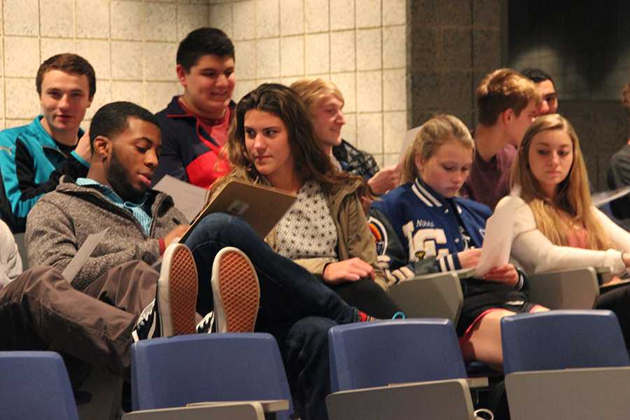 Students look over a list that included different opportunities to receive service hours. At the end of the NHS meeting, students were able to sign up for the event of their choice. 