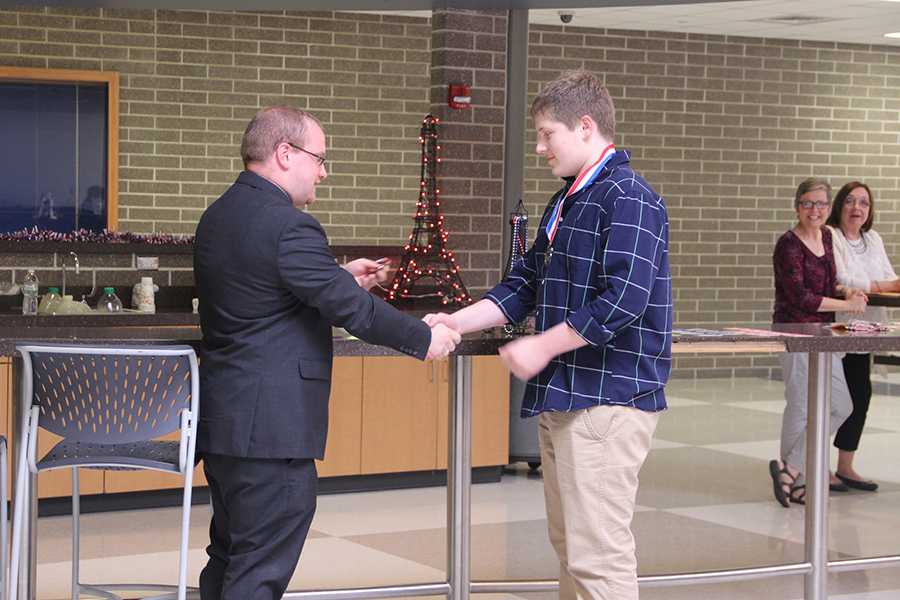 Thomas Pavell (9) receives his medal. This was Pavell’s first year taking the National French Exam and he placed in the silver level nationally. 