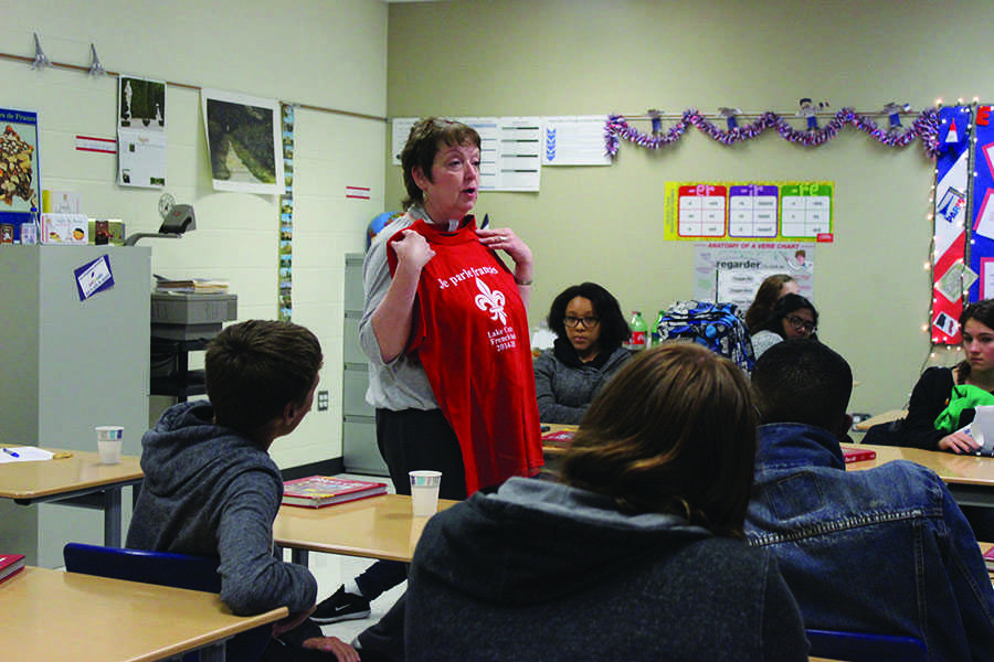 Ms. Bovard discusses t-shirt designs with the class. The previous French club t-shirt said “Je parle Francais”.
