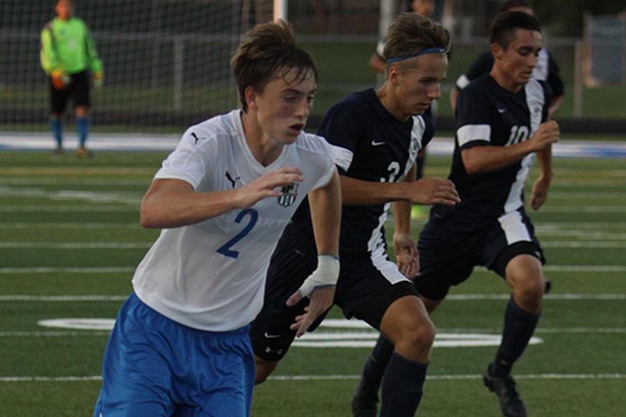 Cole Rainwater (10) blows past the Michigan City defenders in the varsity soccer game on Wednesday, Aug. 24. The team defeated the Wolverines with a final score of 5-0. Photo by: 
Stefan Krajisnik (12)