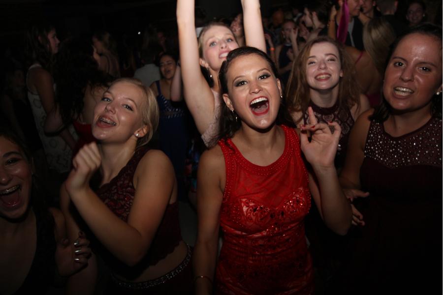 Madeline Andrews (11) dances with her group of friends at the Homecoming dance. Andrews was one of the many students on the dancefloor.