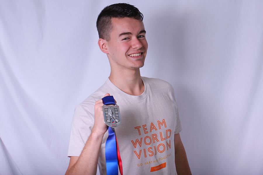 Michael Clark (12) poses with his medal he received after finishing the Chicago Marathon. This was the third time Clark participated in that marathon. 
