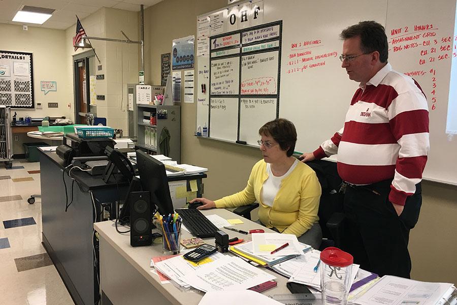 Mr. David Harnish, Science, and Mrs. Roberta Harnish, Science, look over their October schedule together. The Harnishs had been married for 22 years and taught chemistry classes next door to each other.
