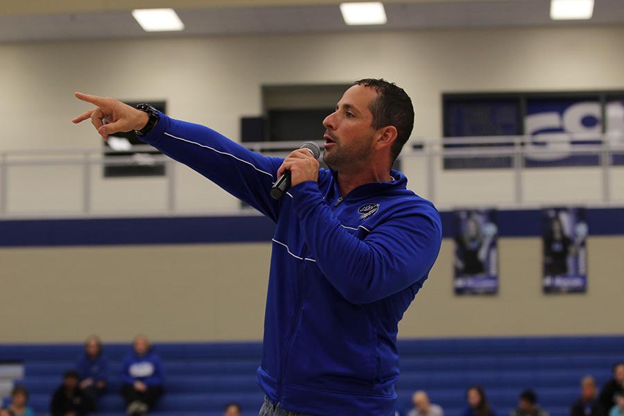 Head coach of varsity football, Tony Bartolomeo, Science, speaks in front of the students body during the Homecoming pep rally. Bartolomeo, who took over as head coach on Sept. 13, coached the team to a 38-0 victory later that day.
