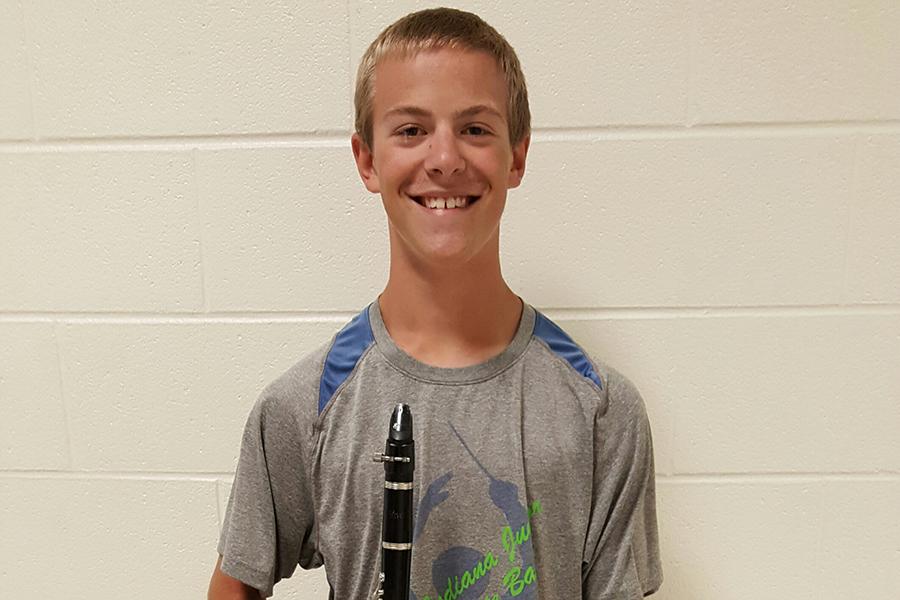 William+Zollman+%2810%29+poses+with+his+clarinet+before+marching+practice.+Zollman+is+a+section+leader+in+marching+band%2C+as+well+as+a+member+of+jazz+band.++%0A