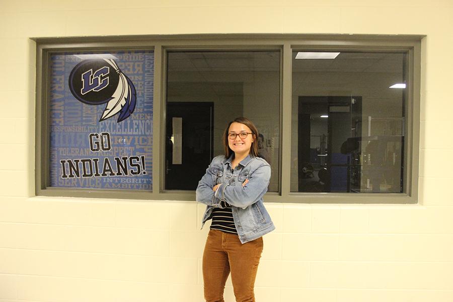 Katie Rusiniak poses in front of the weight room. The team has been without a solid coach for four months. 