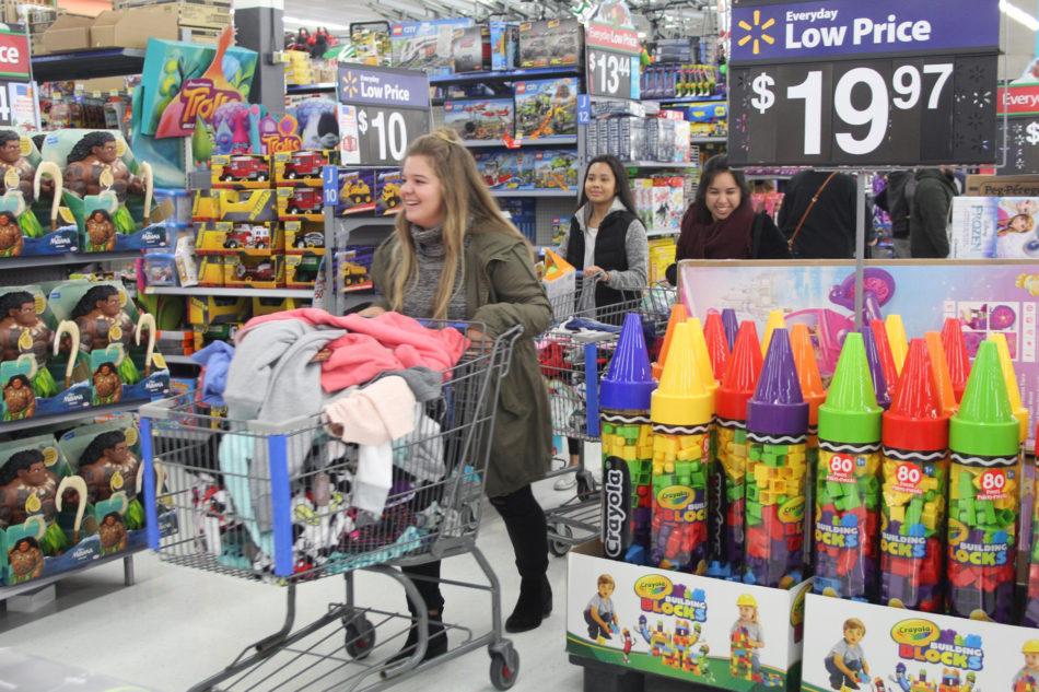 Allison Schuch (12) wheels past the toy section with a cart full of clothes. Schuch was the group leader of the 9-10 year olds. 