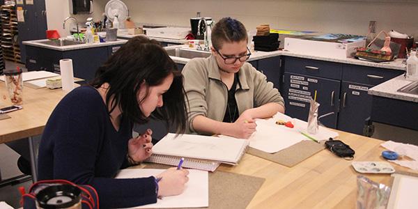 Ryane Kats (10) and Cordelia Weatherby (10) start to plan their piece. They began with their initial sketch. 
