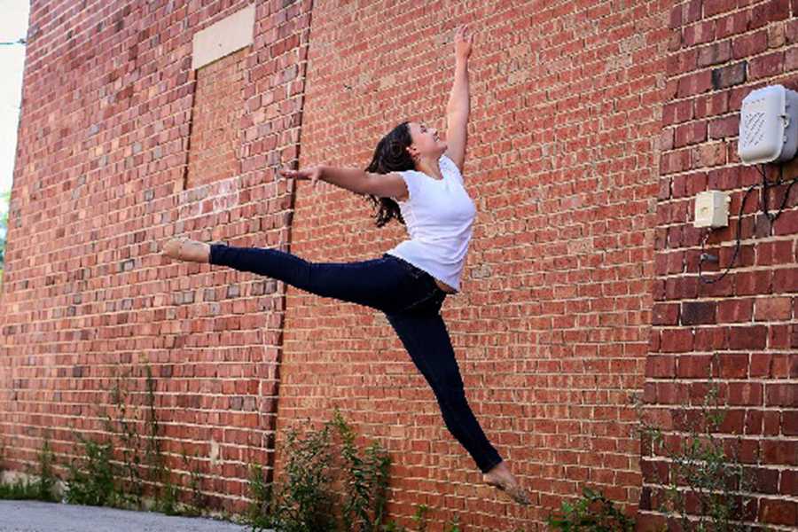 This photo was taken during a photoshoot Katelin did for dance.  Katelin Cunningham (10) does a leap in the air and forms a large smile on her face.  
