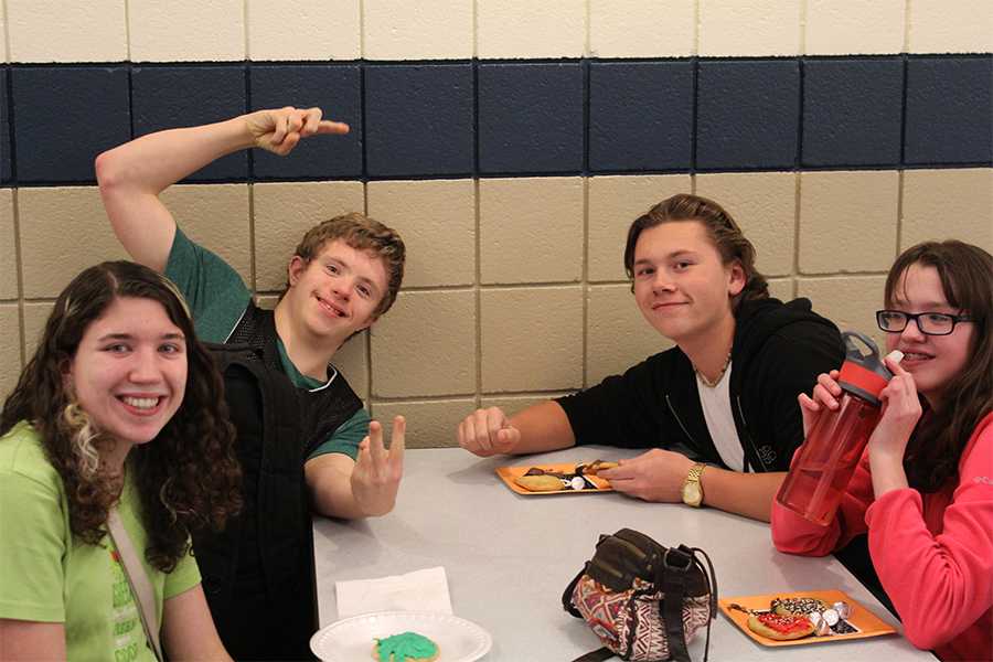 Charlie August (10) interacts with buddies at the Best Buddies meeting. 
The club members decorated cookies and sang along to Christmas music.