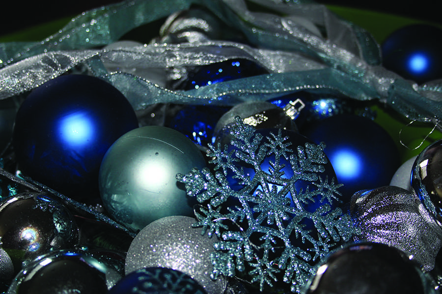 Ornaments lay among a variety of other Christmas decorations waiting to be hung. Lights were also hung from the tree to prepare for the holiday season. 