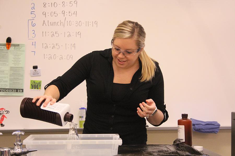  Mrs. Lauryn Vukas, Science, pours hydrogen peroxide in the beaker to begin her demonstration of the elephant toothpaste reaction. Mrs. Vukas then added potassium iodide as a catalyst to speed up the reaction.
