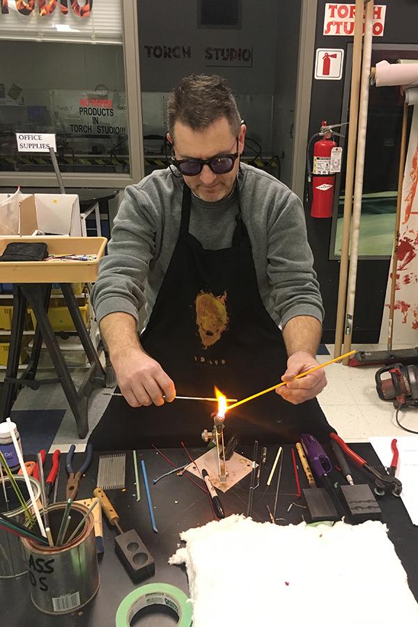 Mr. Paul Volk, Art, uses a torch for one of his current art projects. Art projects made by some of his students can be found on his Weebly page, Studio117.