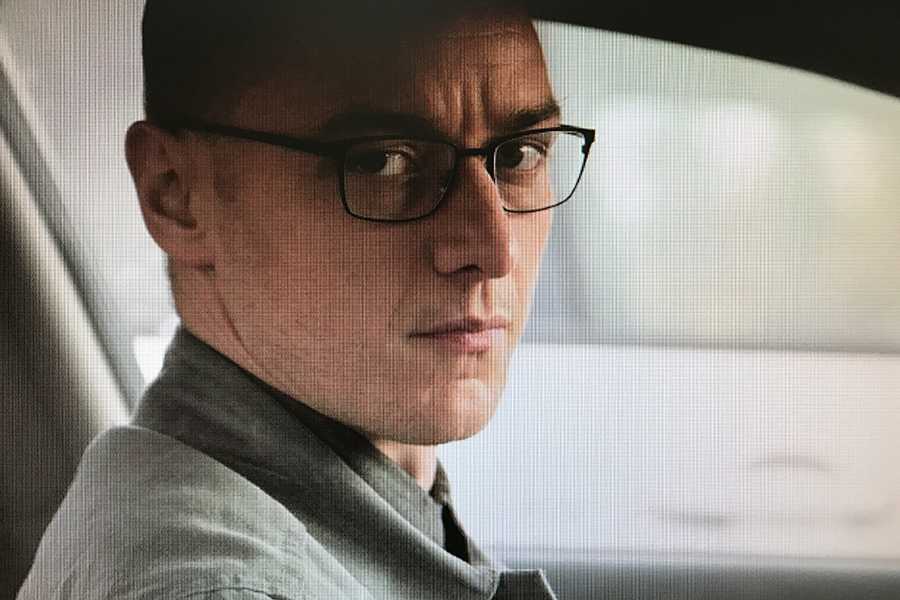 Kevin Wendell Crumb (James McAvoy) watches the three teenagers outside of his car. He suffered from severe dissociative identity disorder. 