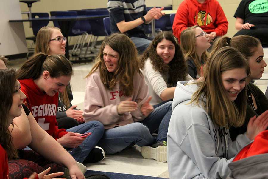 Madison MacLagan (9) and Alyssa Destefano (10) laugh as they clap for the performance. Members were able to form friendships through this club. 
