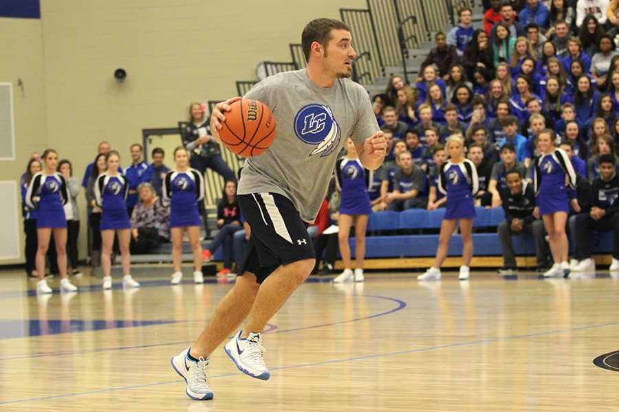 Mr. Andrew Gurnak, Physical Education, runs down the basketball court. Gurnak played in the basketball game between students and staff members.
