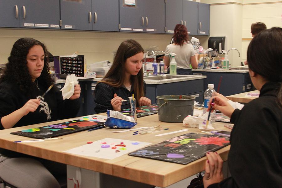 Students continue to work on their individual projects. After the painting had dried, they were able to scrape off their paintings and use them as window decals. 
