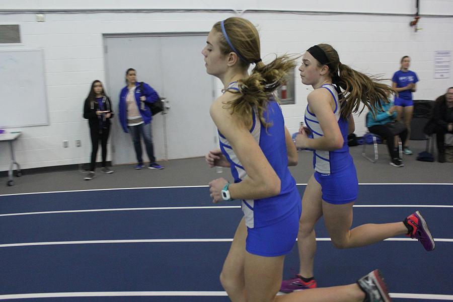 Rachel Kujawa (9) and Lilly Zubeck (9) keep pace together in the mile. Zubeck (second) came in first for the mile and Kujawa (front) came in second.