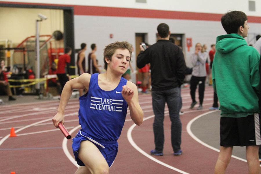 Alexander Miller-Swain (9) sprints down the track in the 4X800-meter relay. Miller-Swain helped bring the boys into first place for the race while he ran. 