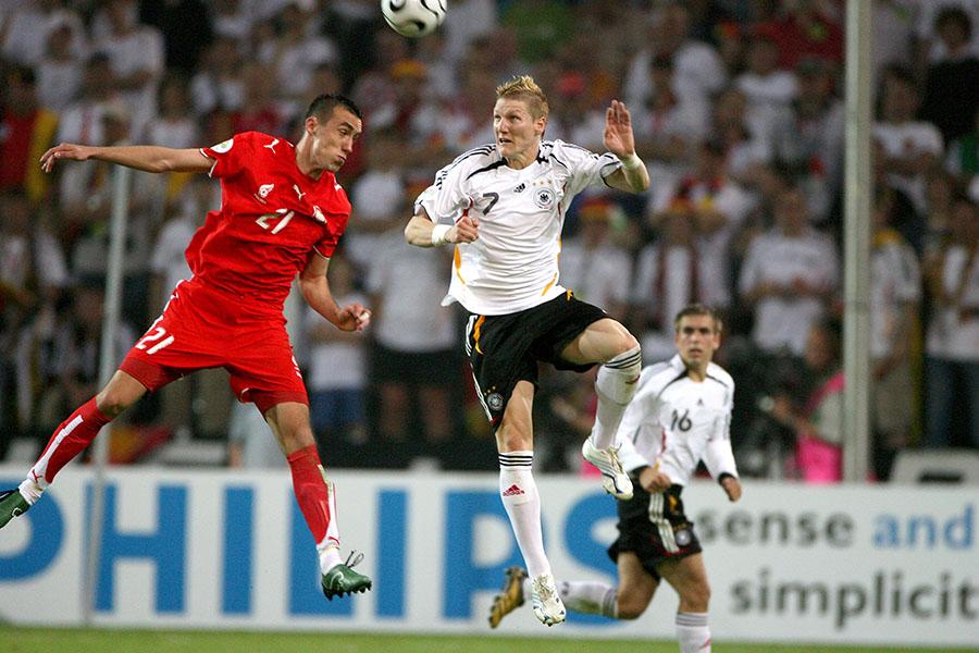 Germanys Bastian Schweinsteiger (7) and Polands Ireneusz Jelen (21) jump for the ball during the World Cup 2006, Group A game in Stuttgart, Germany, Wednesday, June 14, 2006. (Lionel Hahn/Abaca Press/KRT)