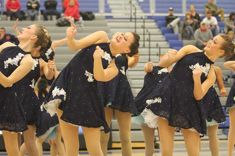 Paige Lambert (9) dances with her teammates during halftime at a basketball game. Lambert danced alongside mostly upperclassmen and is the only freshman on varsity.