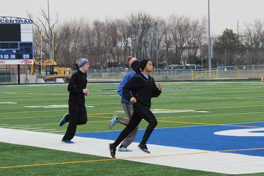Kelani Benson (11) runs around the football field to warm up. The track team had done a lot of practicing in order to prepare for the upcoming meets.