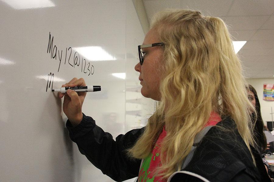 Rachel Frieling (12) writes the details for race day on the white board. Frieling was in Student Council for two years and was the president this year.