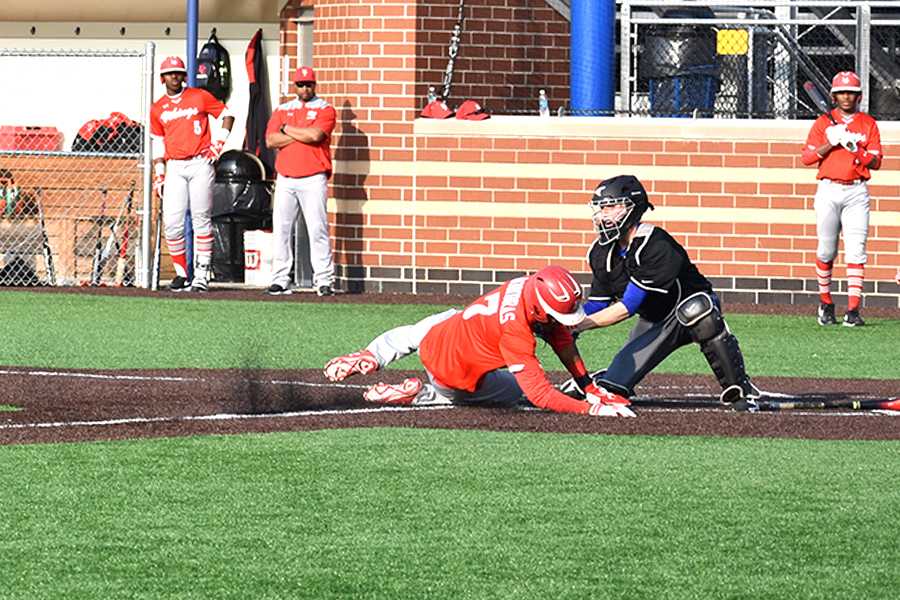 Jarrett Lopez (12) makes an out at home in the fifth inning. The out allowed no runs for Homewood-Flossmoor in the 3-0 win for Lake Central.